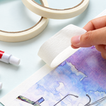 Afplaktape wordt losgetrokken van de rand van een paarsblauwe aquarel.