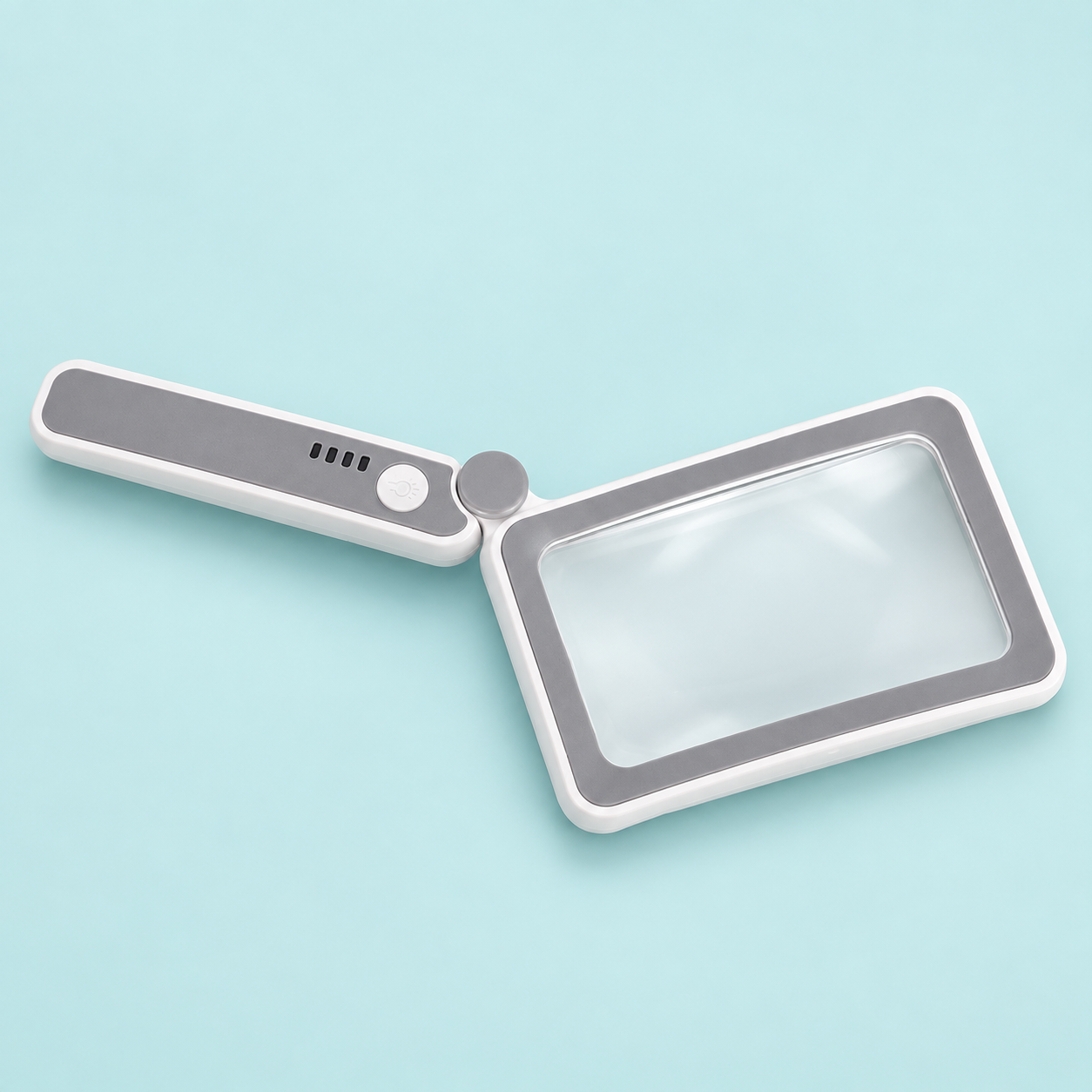 Oplaadbaar ledvergrootglas met rechthoekige lens en uitgeklapt handvat op een zacht turquoise achtergrond